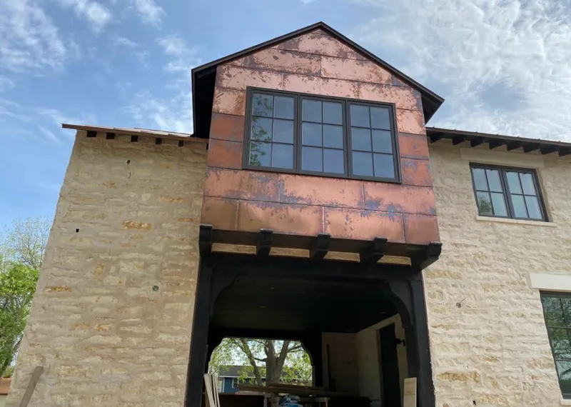 Copper metal panel facade on a stone building for Skylight Installation in Redan